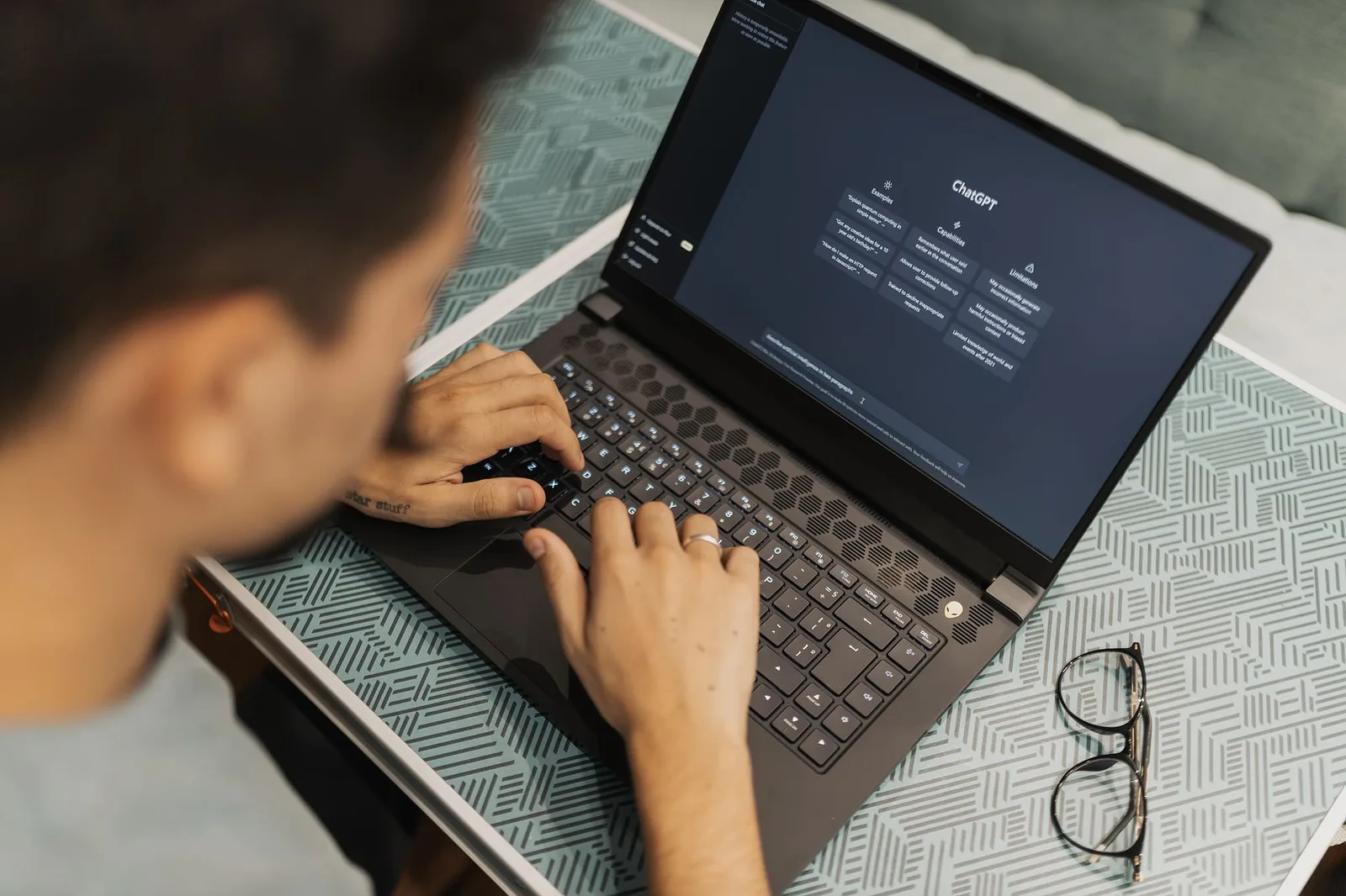 Person working on a laptop displaying a dark software interface